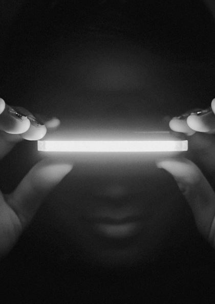 A person holding a light in their hands.